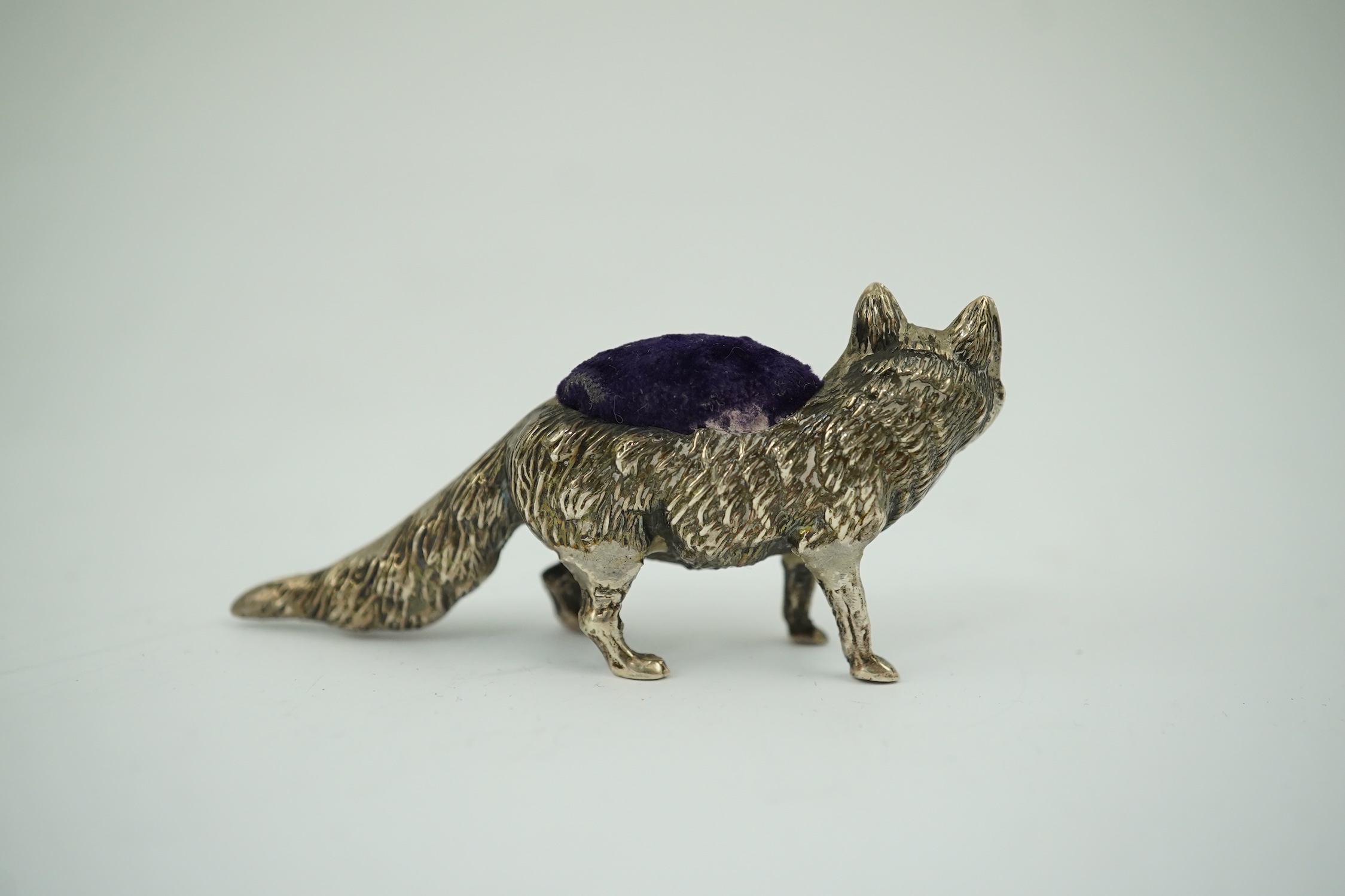 An Edwardian novelty silver mounted pin cushion, modelled as a fox, Levy & Salaman, Birmingham, 1908, length 57mm. Condition - fair to good